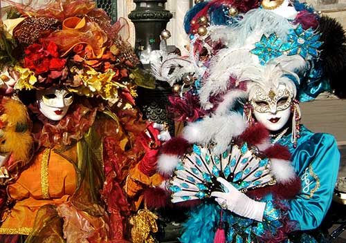 Colorfully dressed Masked Ladies performing a skit at the San Marco Square in Venice